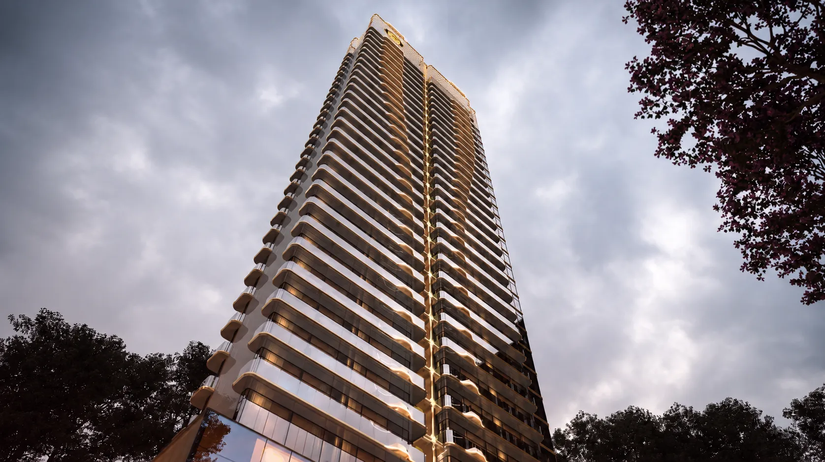 M3M Elie Saab Residences Gurgaon luxury high-rise tower with curved balconies and glass facade at sunset