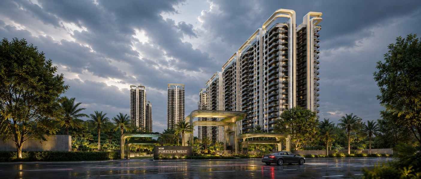 M3M Forestia West residential towers with a landscaped entrance and greenery under a dramatic cloudy sky.