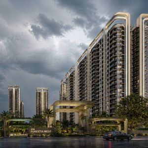 M3M Forestia West residential towers with a landscaped entrance and greenery under a dramatic cloudy sky.